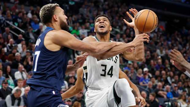 Minnesota Timberwolves center Rudy Gobert (27) fouls Milwaukee Bucks forward Giannis Antetokounmpo (34)